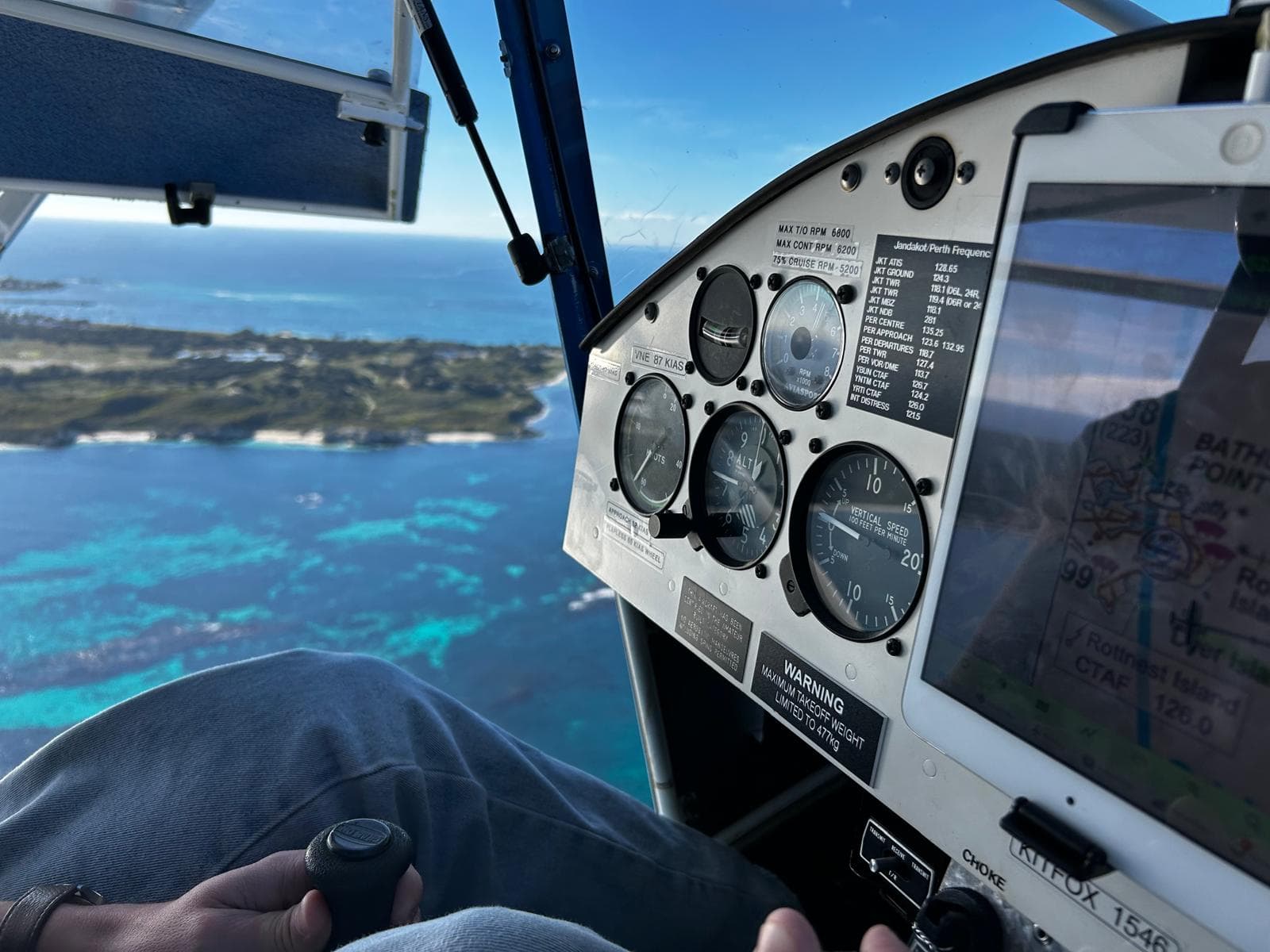 Kitfox cockpit instrument panel in flight, turquoise water and reef below